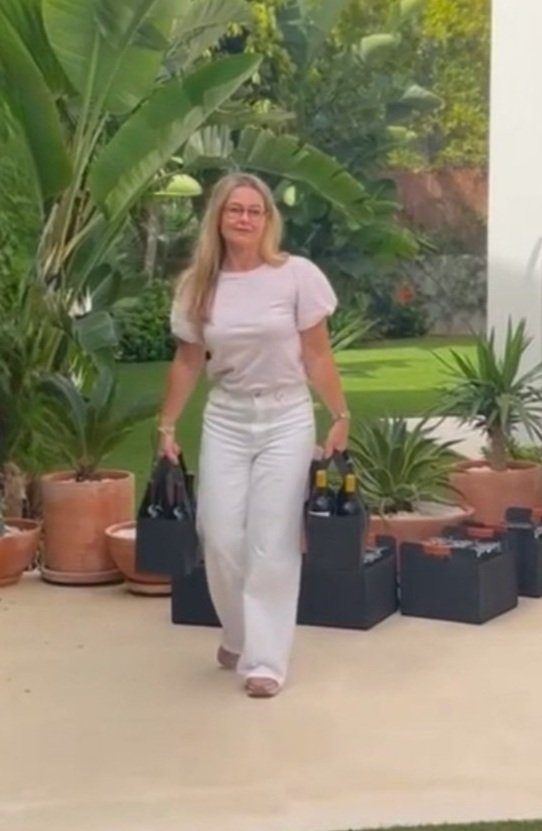 Victoria arriving with bottles of wine for a private tasting at a guest's home